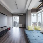 Stijlvolle cinewall met zwevende TV en moderne inrichting in een woonkamer.
